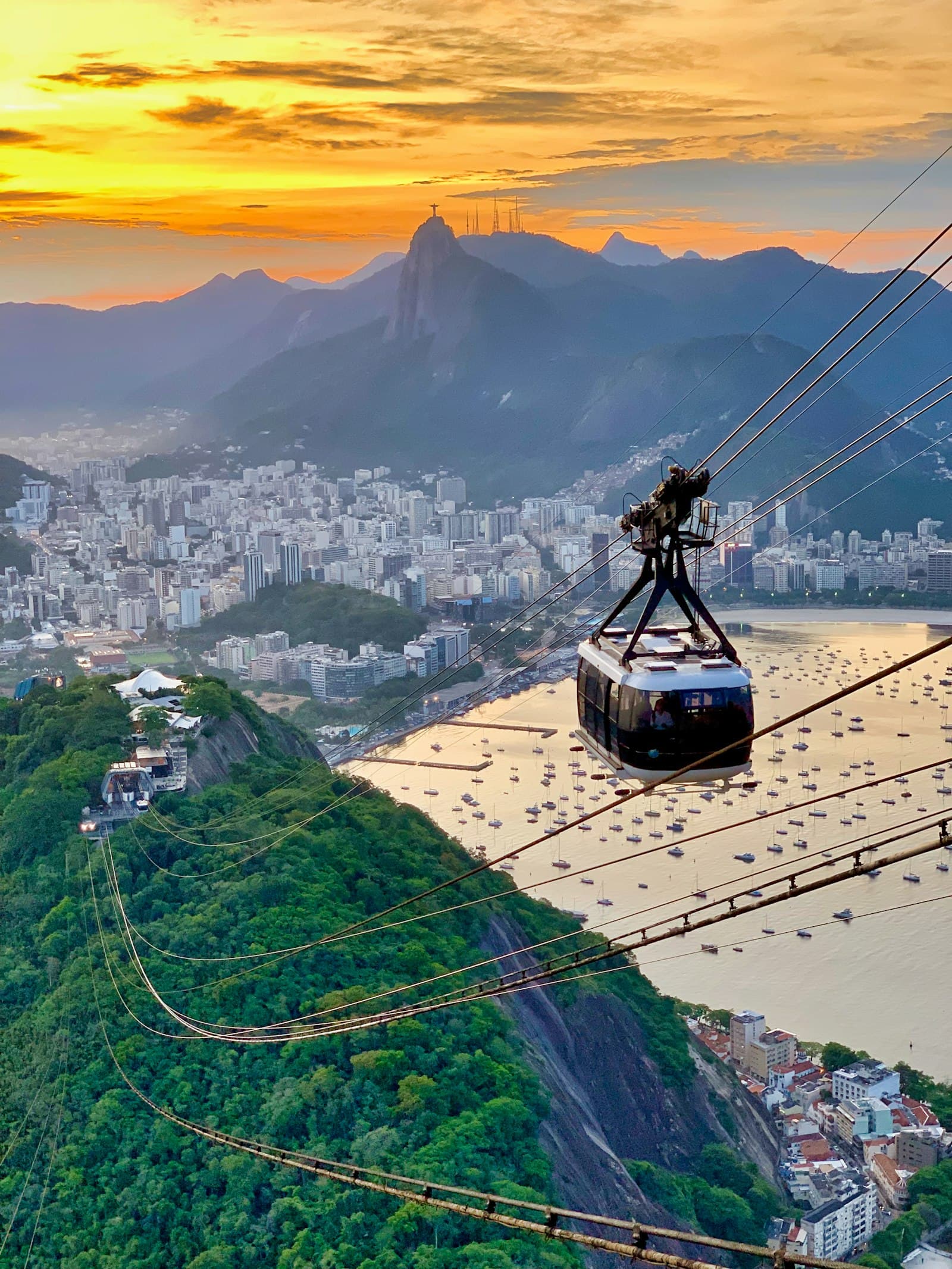 Sugarloaf cable car gliding over Rio de Janeiro at golden hour