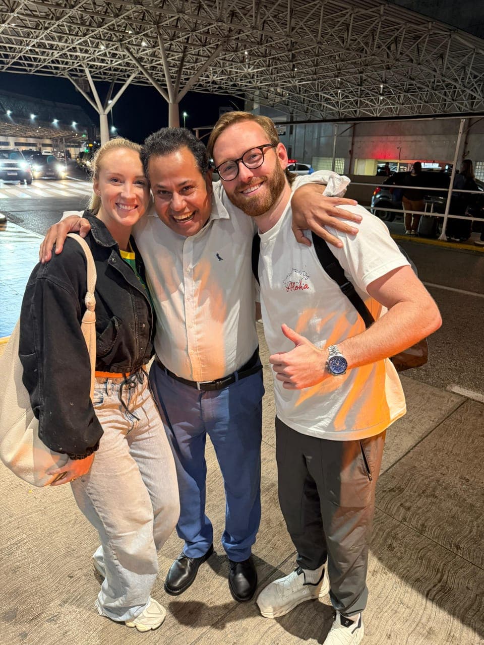 Mohammed of MomoRio with two delighted guests at the airport in Rio de Janeiro